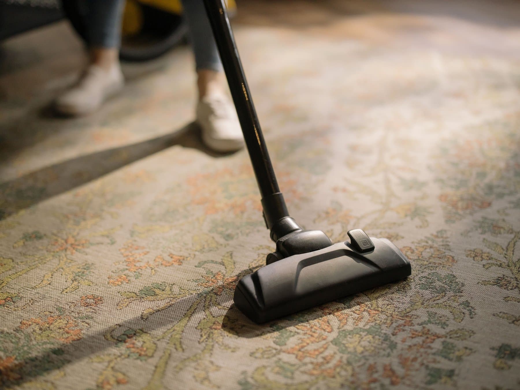Carpet cleaning tool being used on a patterned rug.